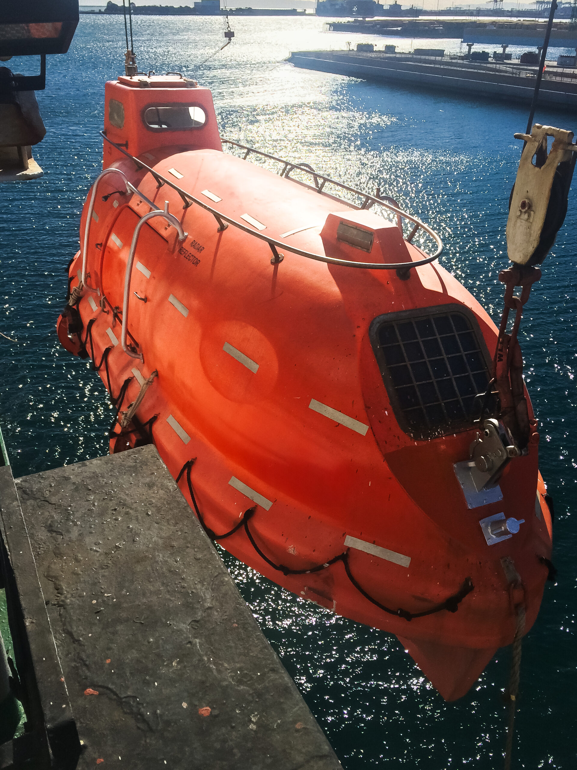 Lifesaving equipment and life boat tests being conducted for compliance inspections on board a ship.